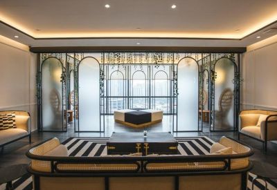 Elegant lounge area with arched glass partitions and plush seating.