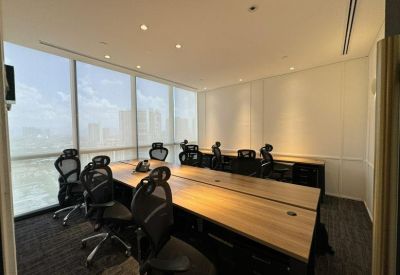 Professional team workspace with large desks and floor-to-ceiling windows.