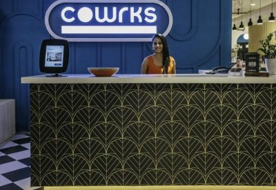 Branded reception desk with a patterned front and blue feature wall.