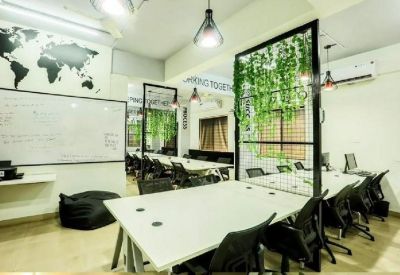 Modern workspace with a world map wall graphic and green foliage accents.
