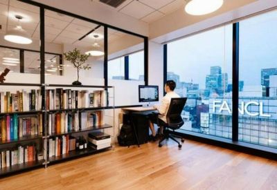 Quiet library workstation with a large window overlooking the city skyline.
