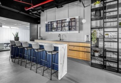 Kitchen area with a blue breakfast bar, wooden cabinetry, and industrial black ceiling.