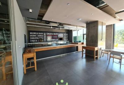 Modern kitchen and coffee station with sleek wooden countertops.