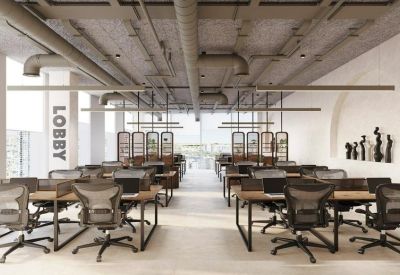 Modern open-plan office with rows of ergonomic chairs and industrial loft-style ceilings.