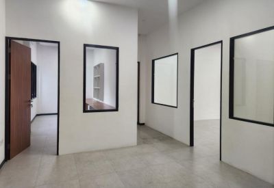 Bright hallway showing multiple glass-walled private office entrances.