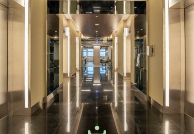Sleek elevator lobby with polished floors and vertical light fixtures.