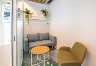 Small private meeting room with comfortable sofas and a coffee table.