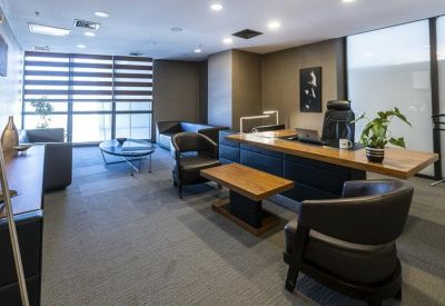 Executive office with modern furnishings and artwork.