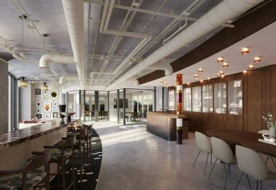 Communal dining area with long wooden tables and stylish pendant lighting.