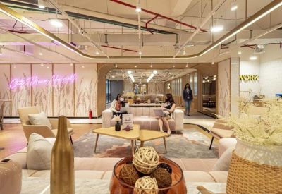 Spacious communal lounge area with plush sofas, coffee tables, and decorative accents.