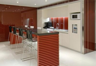 Modern kitchen and breakout area with a red slatted island and sleek white cabinetry.