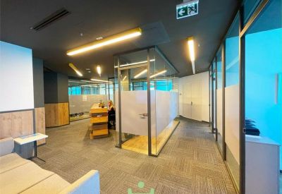 Reception and waiting area with comfortable seating and glass-walled meeting rooms.