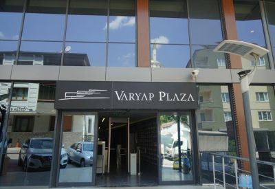 Exterior view of the modern glass and wood facade of the Varyap Plaza building entrance.