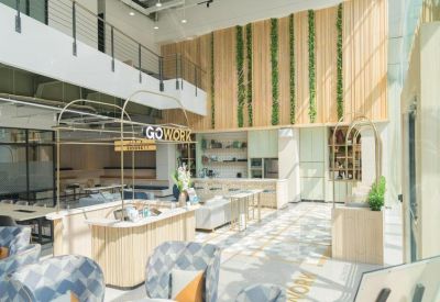 Double-height communal area with a service counter and mezzanine level.