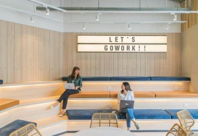 Stepped wooden seating area with blue cushions and modern signage.