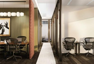 Open-plan workspace featuring ergonomic chairs, wooden desks, and artistic wall decor.