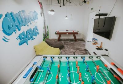 Game room featuring foosball, billiards, bean bags, and blue graffiti wall art.