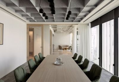 Large boardroom featuring a grey waffle ceiling and dark green upholstered chairs.