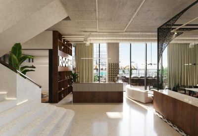Spacious reception lobby featuring a grand staircase, warm wood accents, and floor-to-ceiling windows.