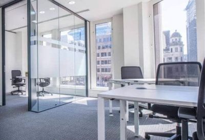 Modern workspace featuring glass partitions and views of the city skyline.