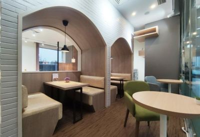 Arched wooden seating booths in a cozy communal lounge area.