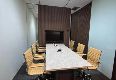 Six-person meeting room with a marble-topped table and built-in wall monitor.