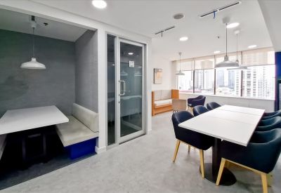 Spacious communal dining area and lounge at Menara Cakrawala with blue seating and modern lighting.