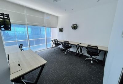 Internal four-person office suite with large windows.