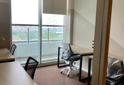 Three-person office suite with light wood desks and window view.