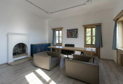 Private office with a fireplace and two armchairs.