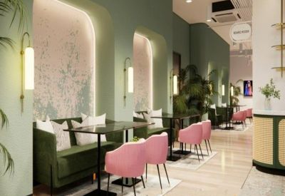 Chic communal area with pink chairs and wall lighting.