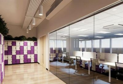 Open-plan workspace with white desks and large windows.