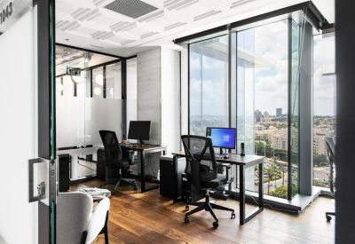 Modern two-person office suite featuring glass walls and expansive city views.