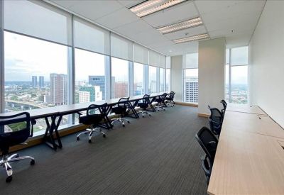 Spacious open-plan workspace at Palma Tower with window-facing desks and expansive city views.