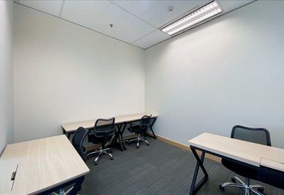 Private internal office suite with three workstations and grey carpeting.