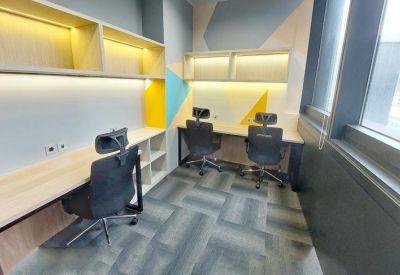 Small private office room with three workstations and bright accent wall colors.