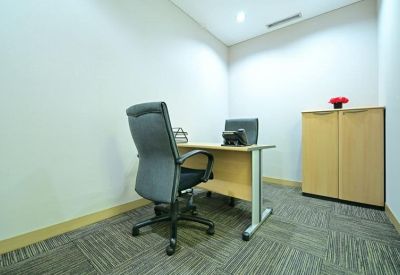 Private windowless office suite with a wooden desk and gray executive chair.
