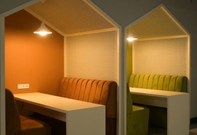 Close-up of integrated work pods with built-in tables and pendant lighting.