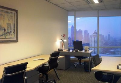 Private office suite with multiple workstations and large windows overlooking the Jakarta skyline.