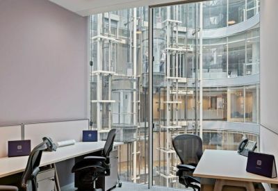 Modern workstations with views of an internal glass atrium.