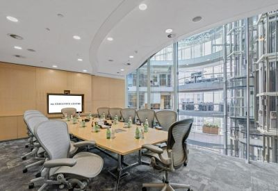 Large boardroom with natural light and glass walls overlooking the atrium.