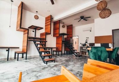 Private windowless office suite with a white desk and ergonomic chair.