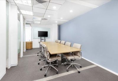 Bright conference room with light wood table and ergonomic chairs.
