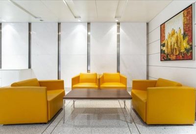 Sleek lounge area with vibrant yellow armchairs and a modern coffee table.