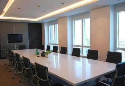 Spacious boardroom with a large white table and floor-to-ceiling windows.