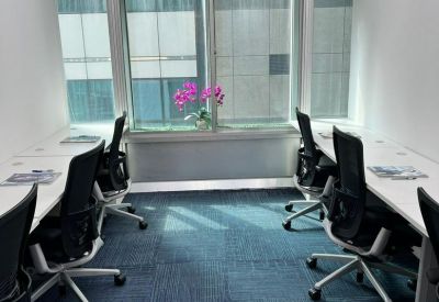 Bright internal office suite with six workstations and blue carpet tiles.