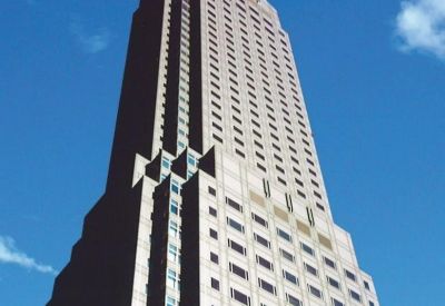 Exterior view of the towering stone and glass skyscraper of Cerulean Tower.