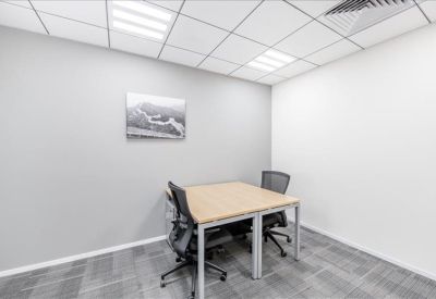 Private office suite with two desks and framed wall art.