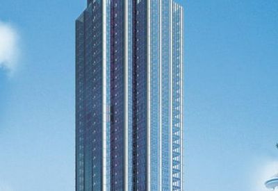 Exterior view of the glass-facade Chong Hing Financial Centre towering into a blue sky.