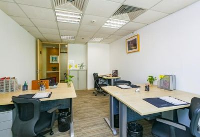 Private office suite with two wooden desks and ergonomic black chairs.